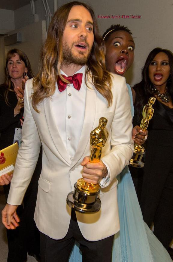 After winning the Oscar for Best Supporting Actress, Lupita Nyong'o accidentally bumps fellow winner Jared Leto backstage